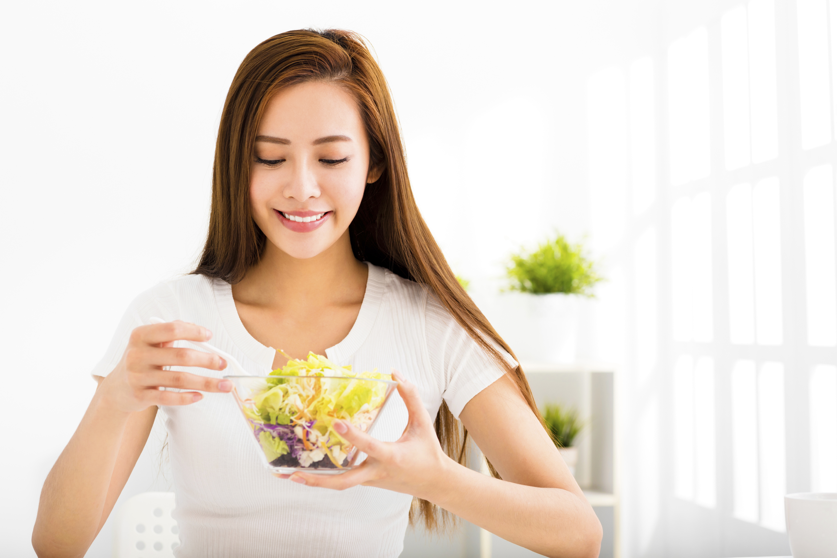 beautiful young woman eating healthy food